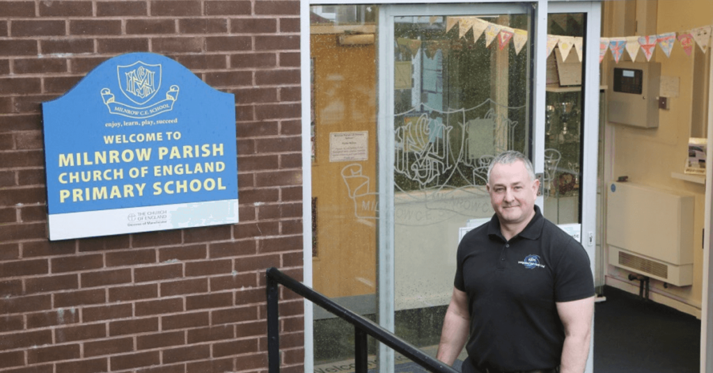 Antony Grace from ASH Integrated Services stood outside Milnrow Parish Primary School