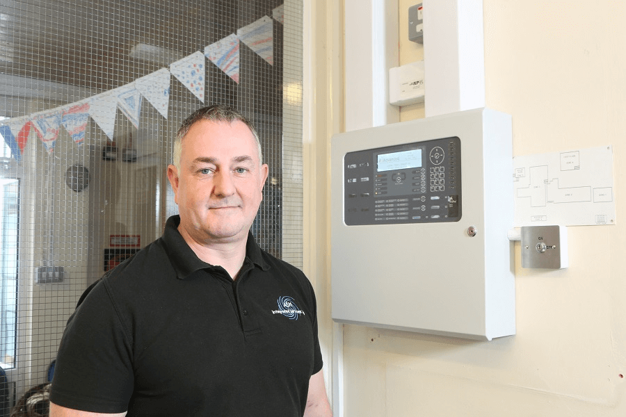 Antony Grace from ASH Integrated Services stood in front of an electrical panel