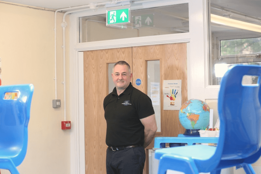 Antony Grace from ASH Integrated Services stood inside a classroom at Milnrow Parish Primary School