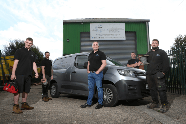 Antony Grace, Director of ASH Integrated Services, stood with their apprentices standing in front of a van