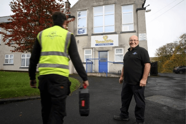 Sean Jackson, one of the directors of ASH Integrated Services stood with one of their employees wearing a high vis vest