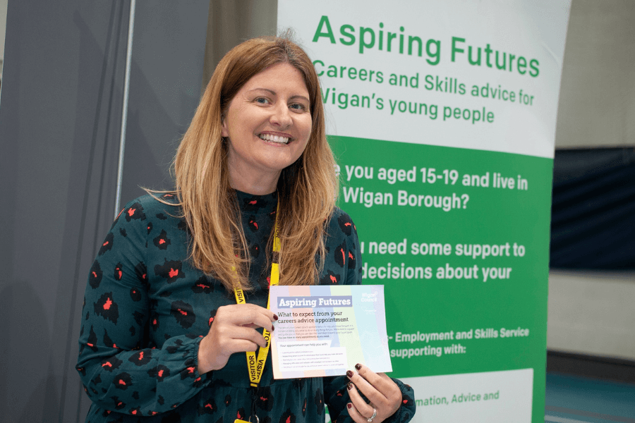 Suzie Voss holding up a sign that says aspiring futures