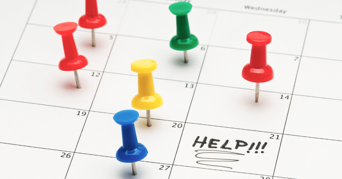 colorful push pins on a calendar with the word help written on it