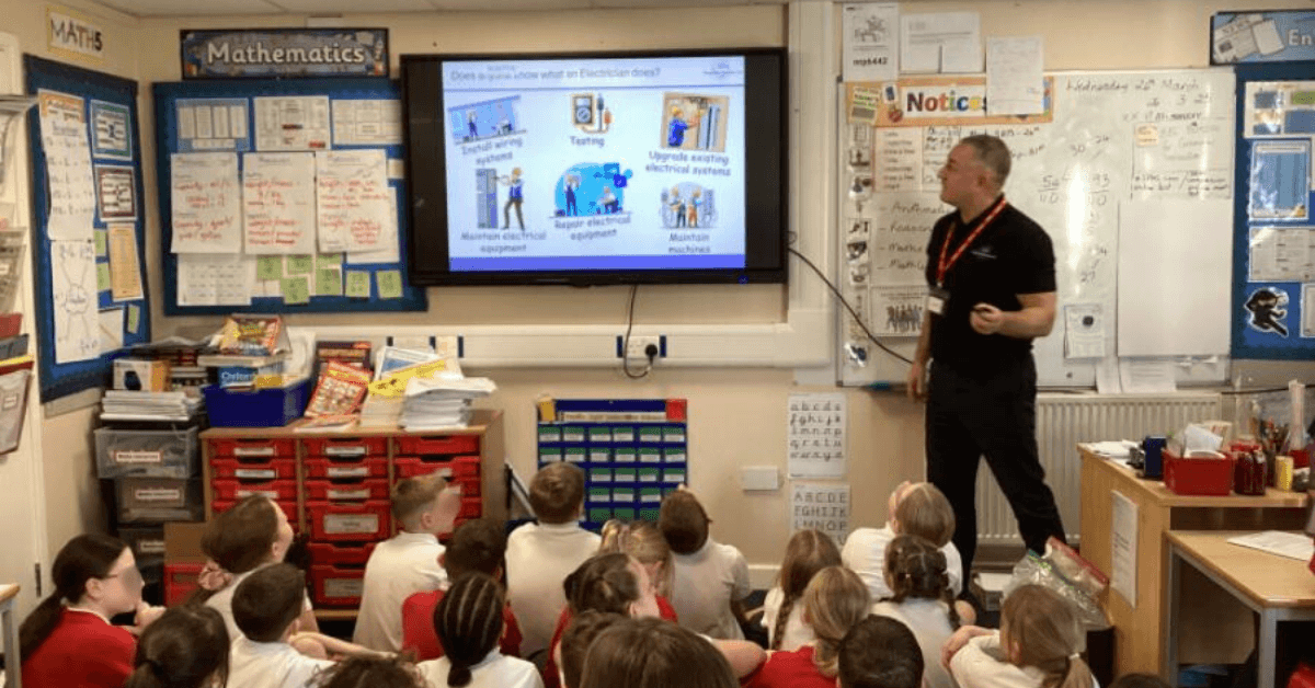 Antony Grace in a classroom talking to primary school children