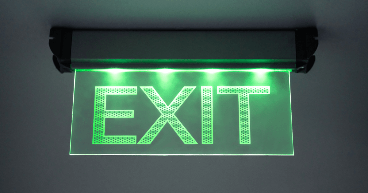 Image shows emergency exit sign lit up in green