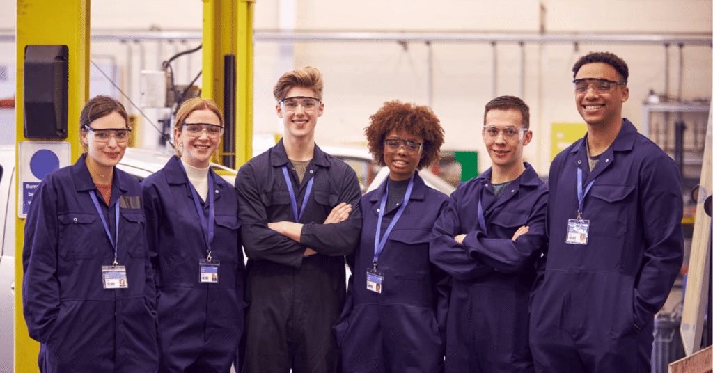 Image shows six young people in blue boiler suits with lanyards around their necks