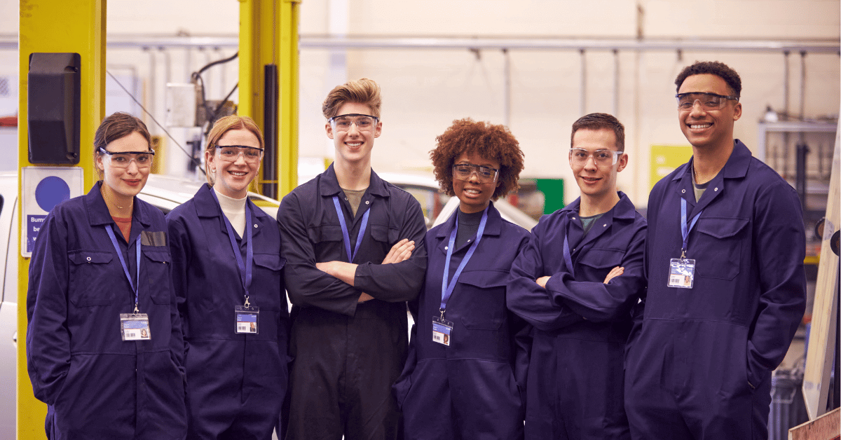Image shows six young people in blue boiler suits with lanyards around their necks