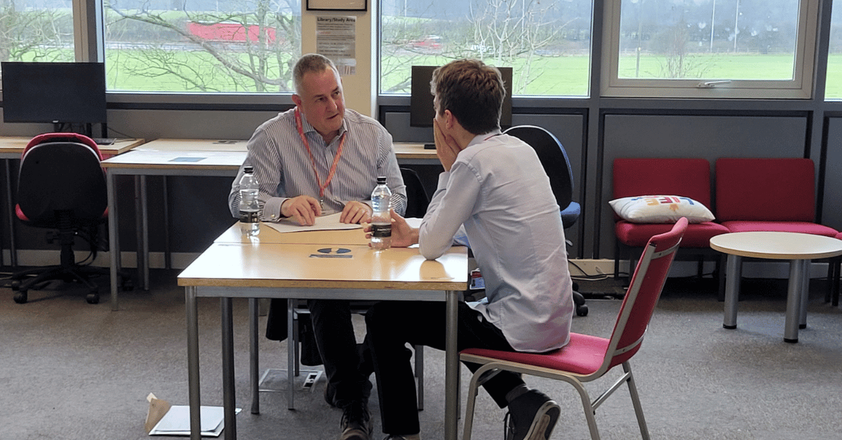 Two people sat at a table talking