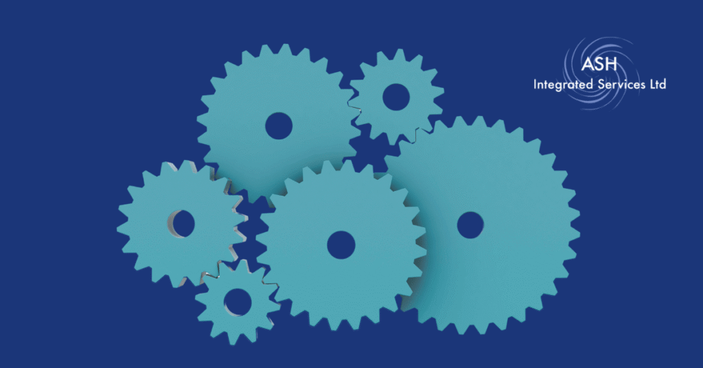 Image shows light blue cogs on a dark blue background with the ASH Integrated Services Logo in the top left hand corner