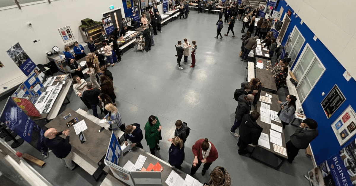 Image of people gathered in a school sports hall for options evening
