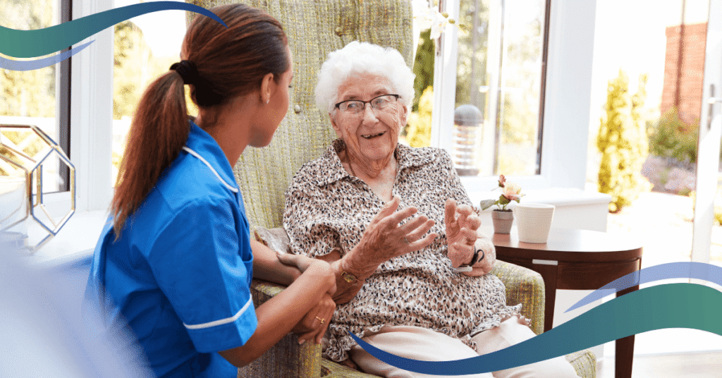 a nurse talking to an elderly person in a chair