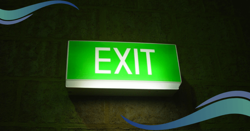 Image shows emergency exit sign lit up in green