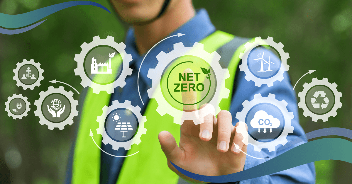 Image shows worker in high vis vest pointing at cogs on a screen depicting all the element of net zero