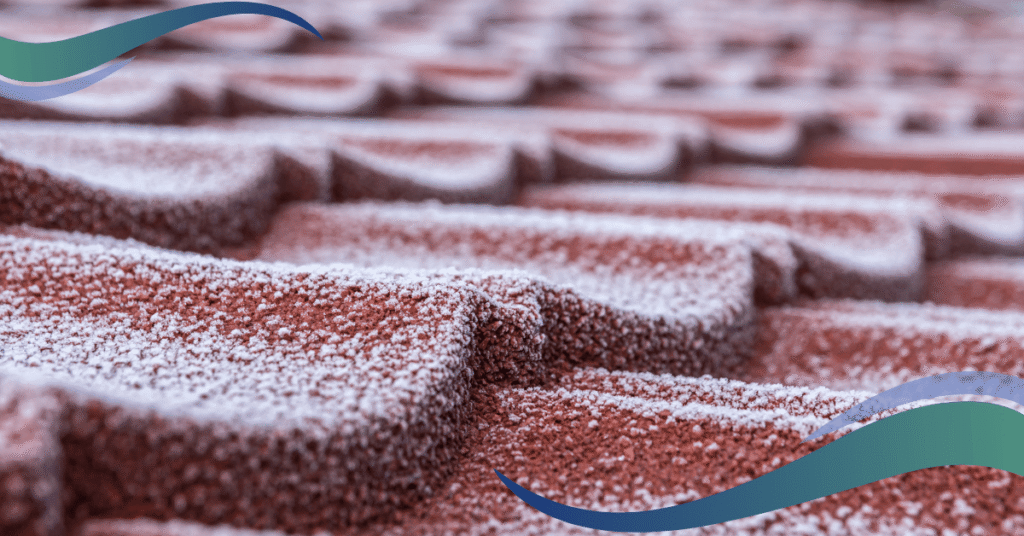 Image shows rusty red frosty roof tiles